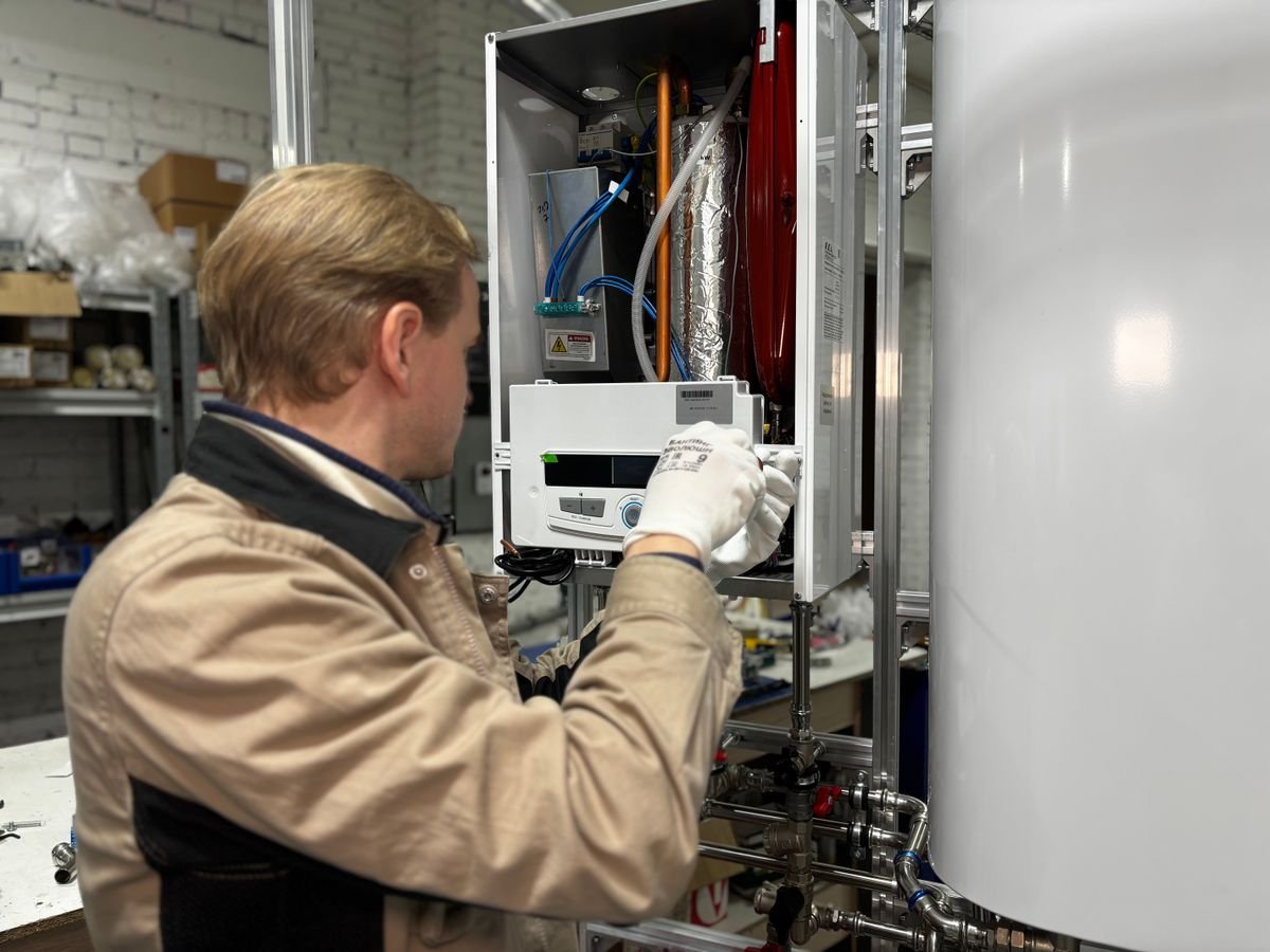 Technician installing a commercial water heater unit