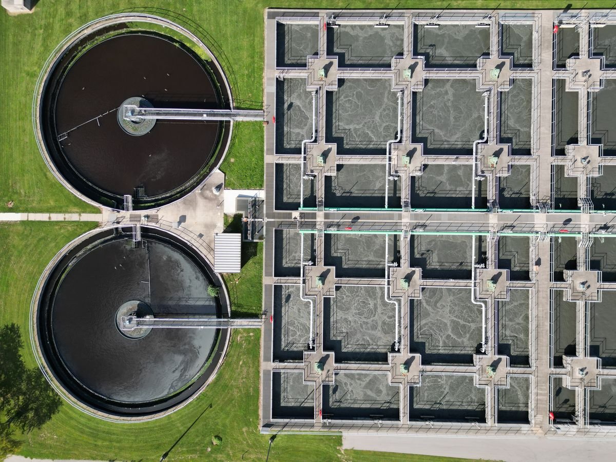 Aerial view of circular clarifier and aeration tanks at a wastewater treatment plant